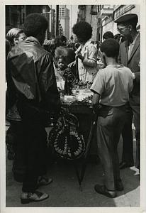 People at Street Retailer Stand Chris Mackey Photo 1970